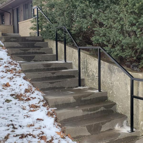 black 1-1/2" square tubing was used on this out door railing going up a concrete stair case