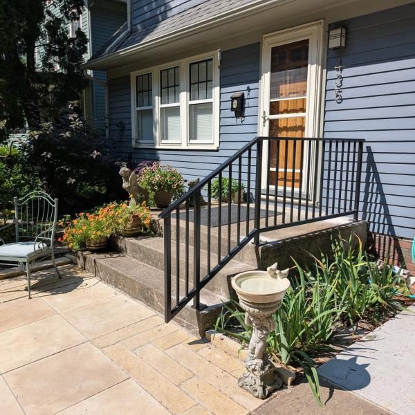 Black Metal Railing connected to the concrete porch
