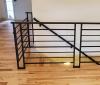 side profile of a horizontal flat black modern railing set 