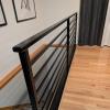 close up view of the horizontal flat black railing