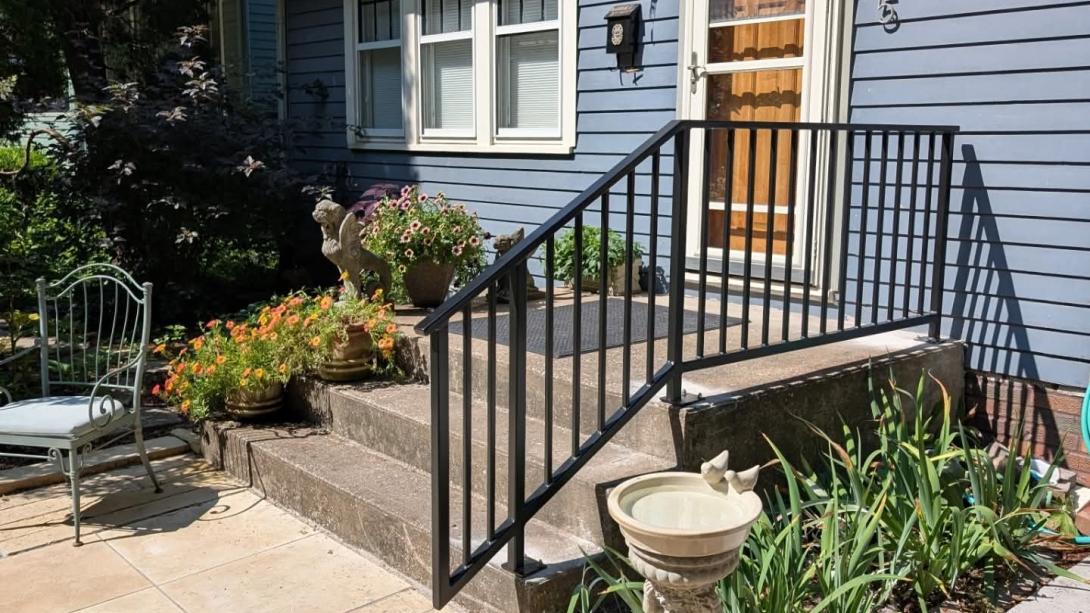 Black Metal Railing connected to the concrete porch